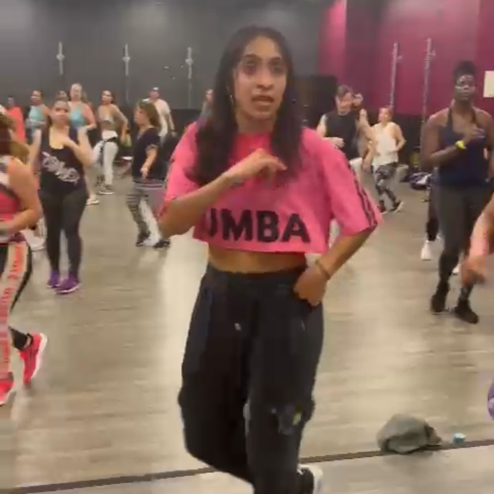 Maria teaching her Zumba class in Coral Springs, Florida, leading a group with high energy and upbeat music