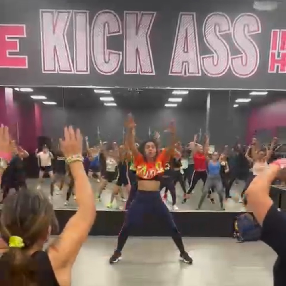 Maria leading a packed Zumba with Maria in Oakland Park class, full of energy and movement